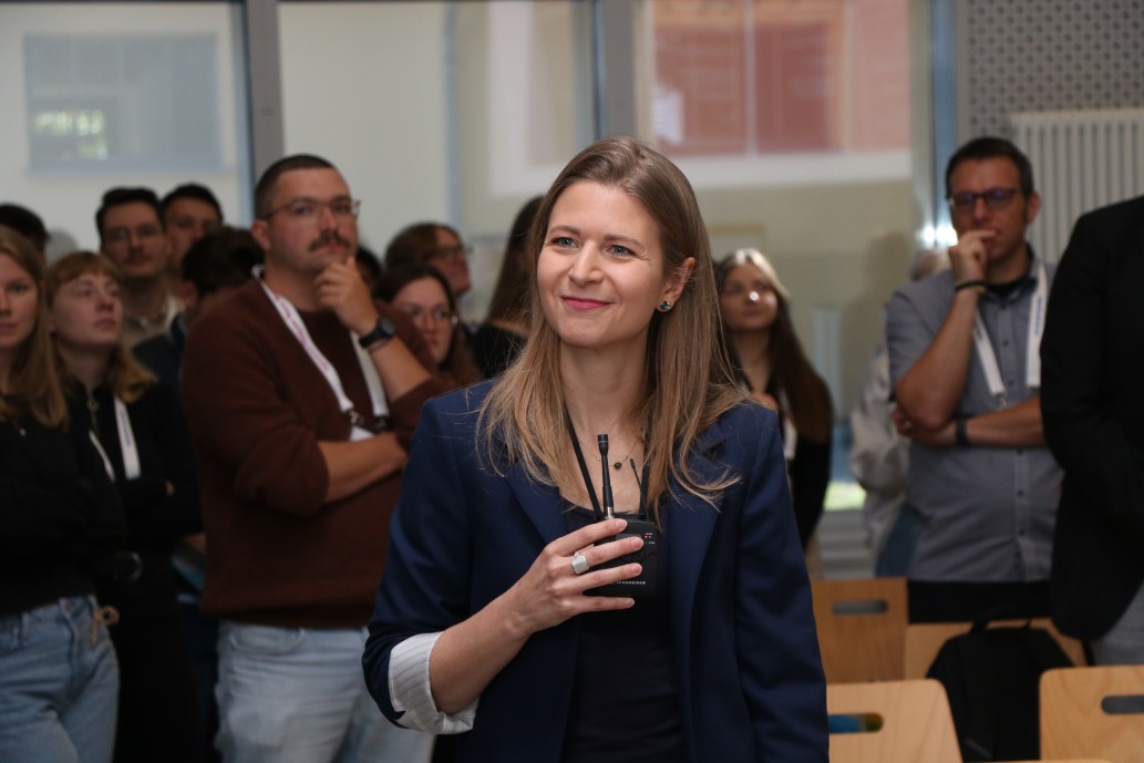 Woman with a microphone holding a speech
