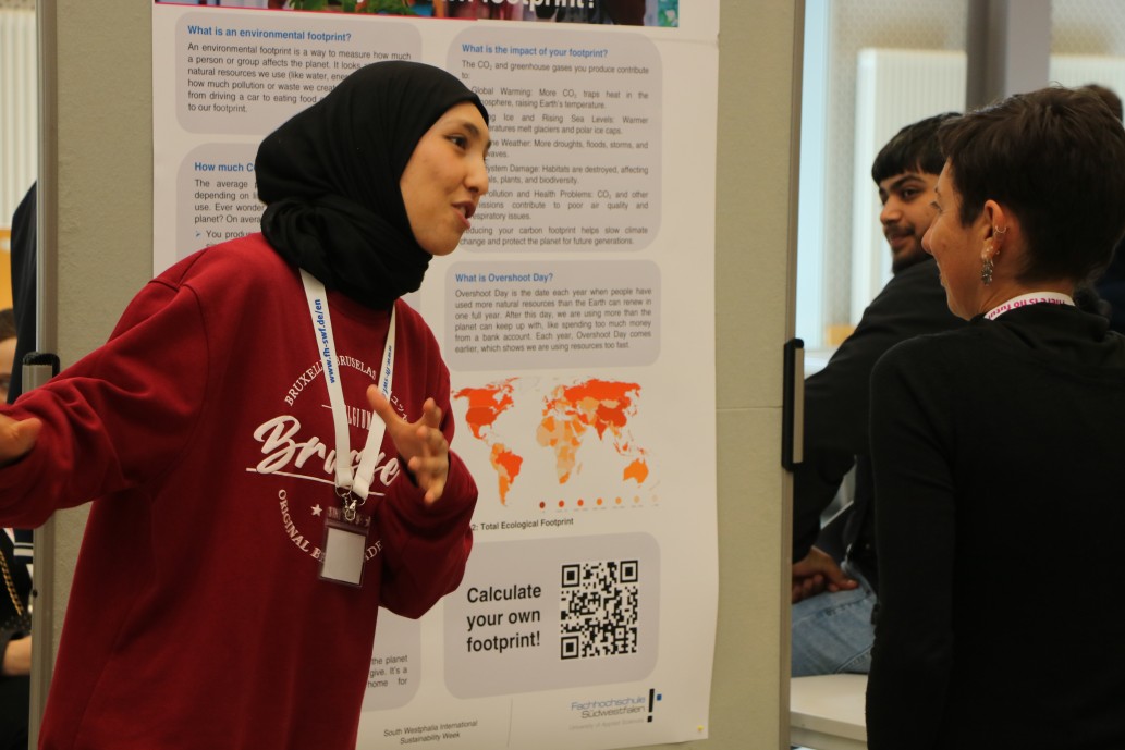 Young woman presenting group results on poster